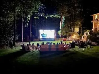 Private Backyard Outdoor Movie Night Rental with Screen and Seated Guests in Colorado Springs, Colorado