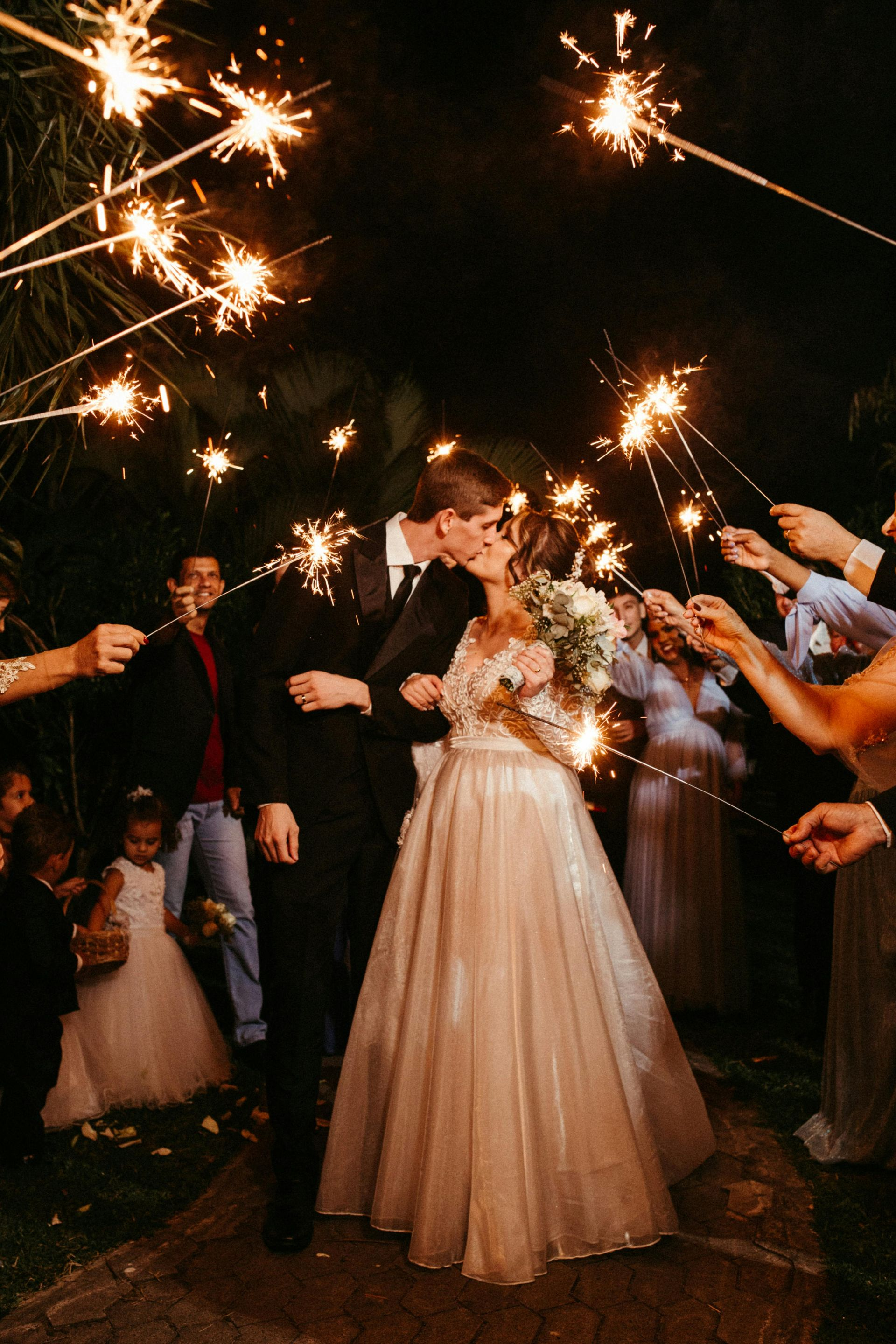 Newlyweds Exit Through Sparkler Tunnel at Elegant Night Wedding with Professional Audio Visual Support in Colorado Springs.