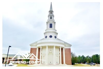 A large church with a steeple on top of it.