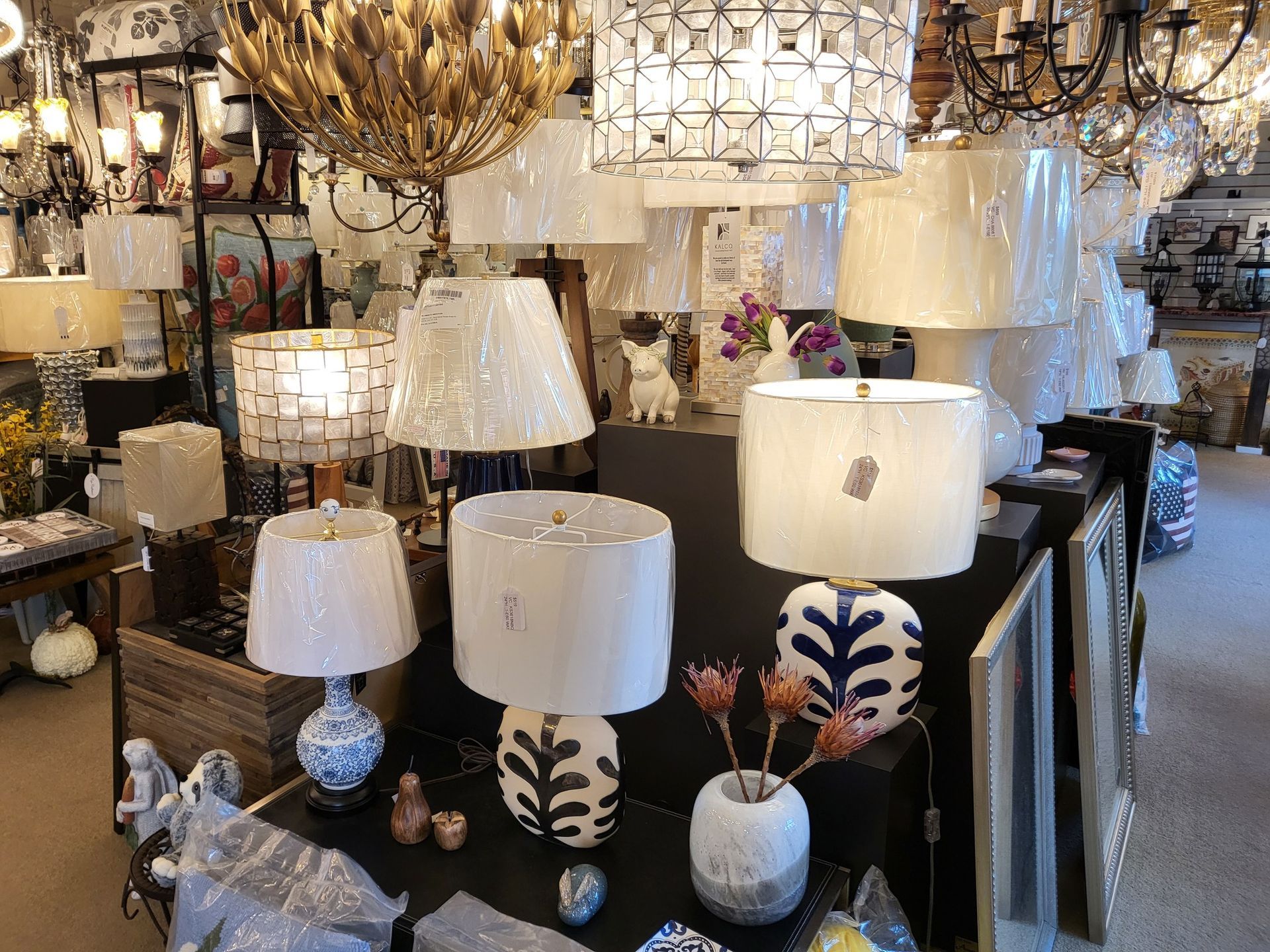 a display of blue and white lamps with white shades