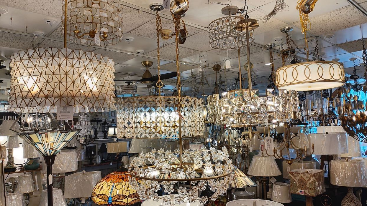 a store filled with lots of chandeliers and lamps