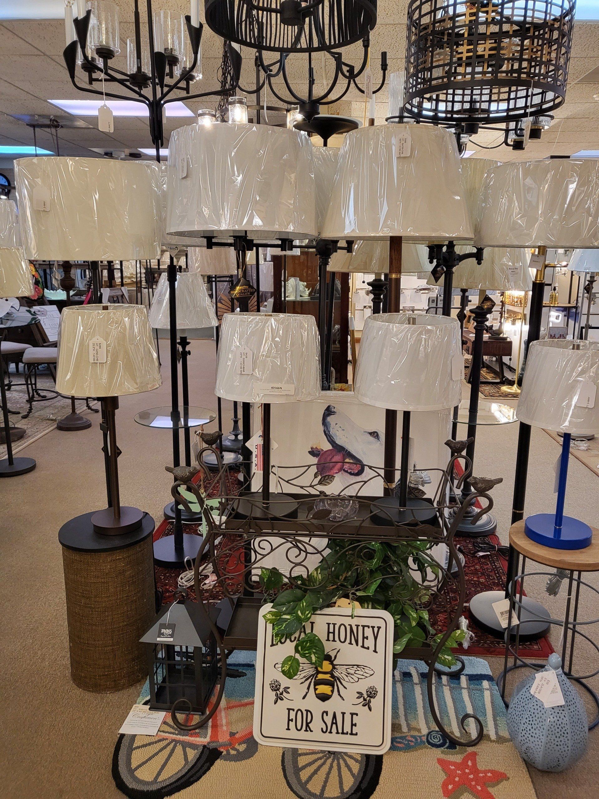 A display of lamps and a sign that says honey for sale