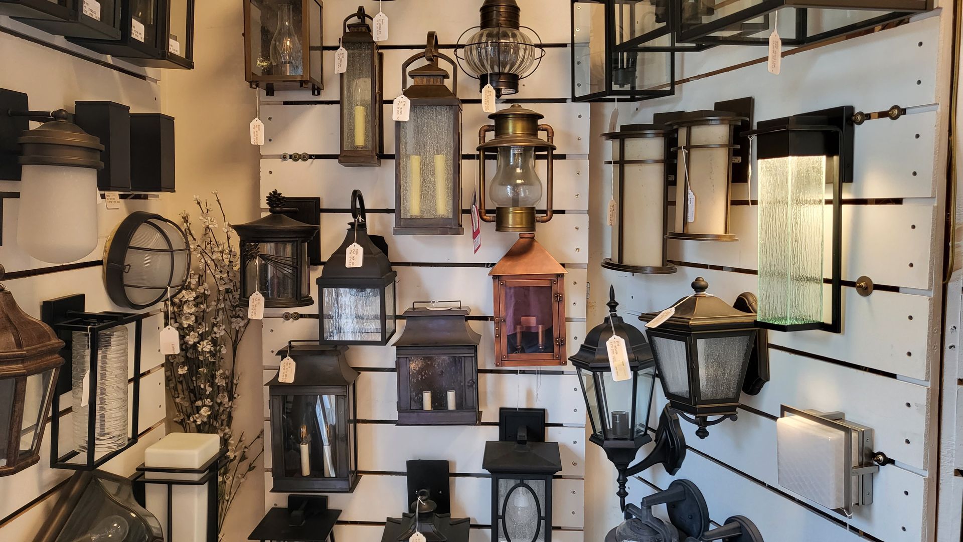 A display of lanterns on a wall in a store