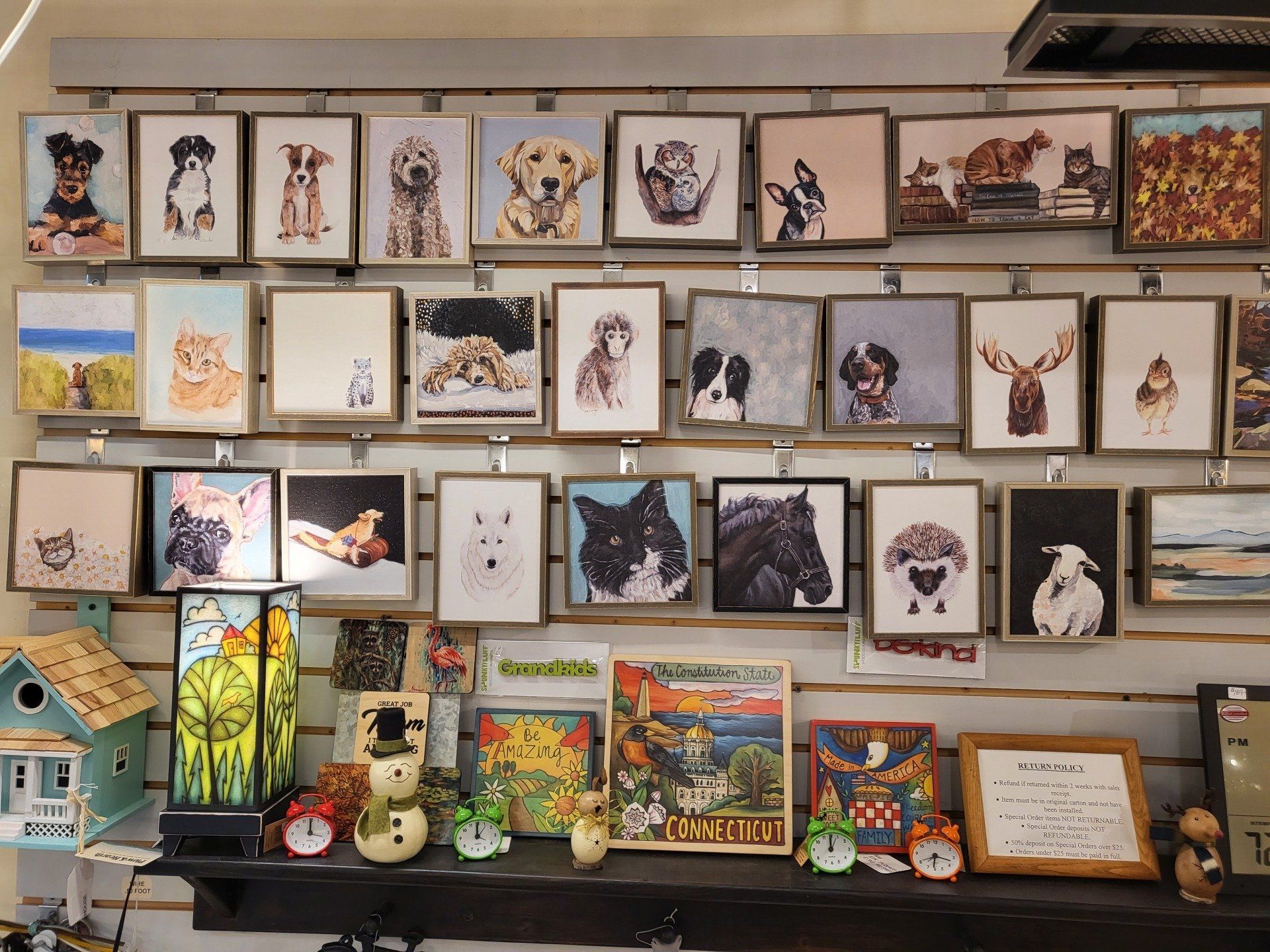 A wall filled with pictures of dogs and cats