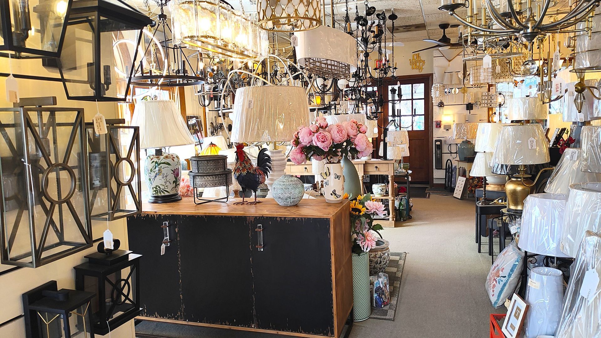 A retail store filled with lots of lamps hanging from the ceiling in Avon, CT.