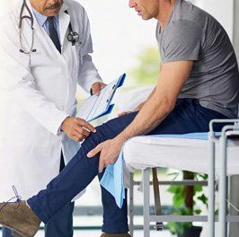 Chiropractor checking leg knee