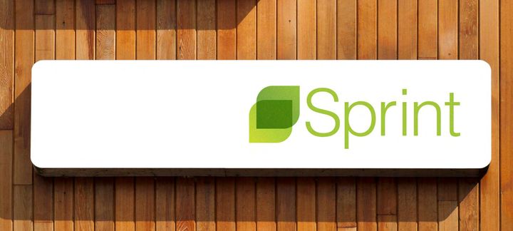 a white sign that says sprint on a wooden wall