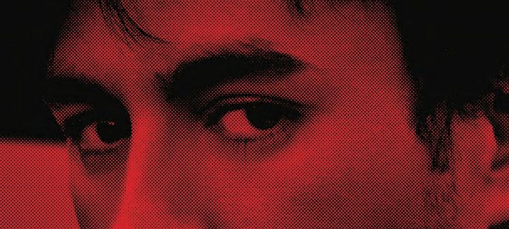a close up of a man 's face with a red background .