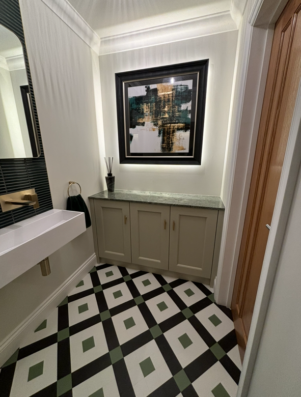 Bedroom with a mustard yellow bed, wooden nightstand, and floral patterned drawer.