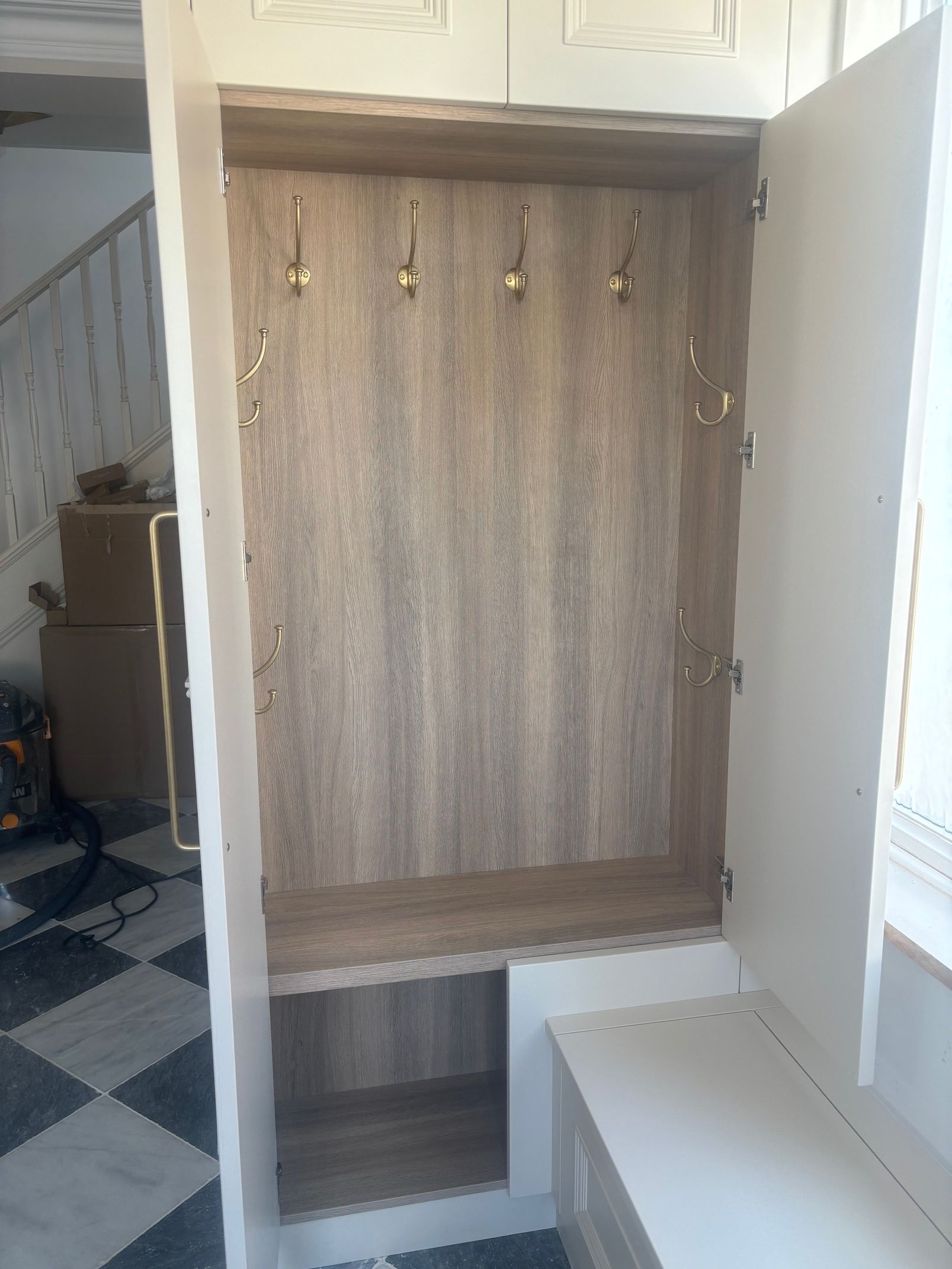 Close-up of a recessed ceiling light surrounded by diamond-shaped wood paneling on a slatted wood ceiling.