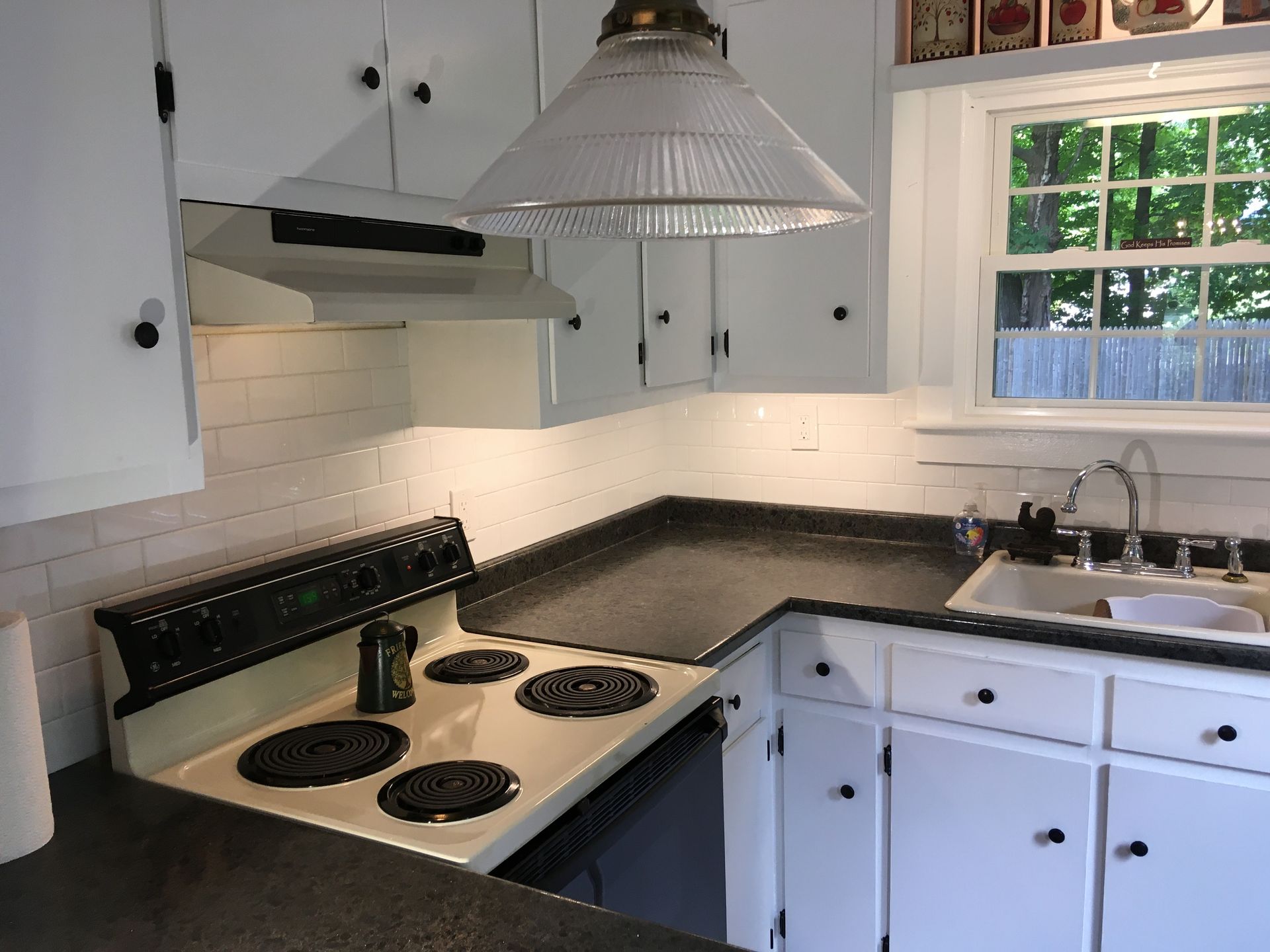 A kitchen with a stove top oven and a sink