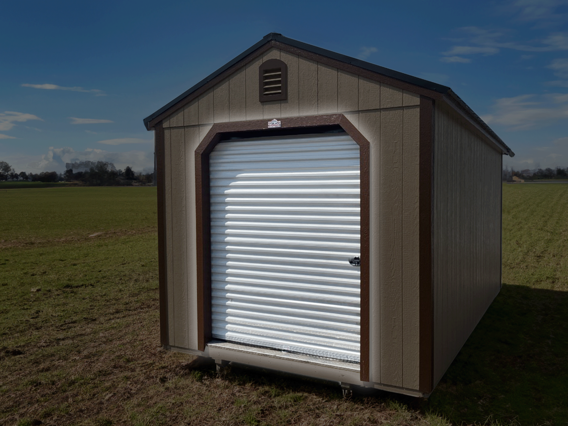 A shed with a white door is sitting in the middle of a field highlighting a Garage Door add on