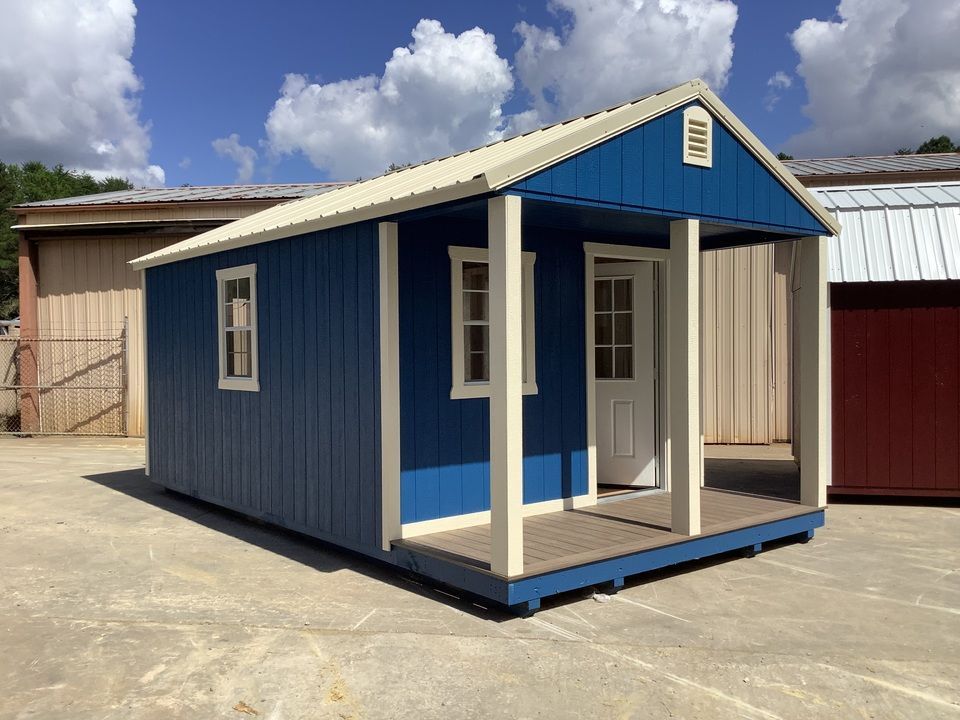 A blue cabin with a porch