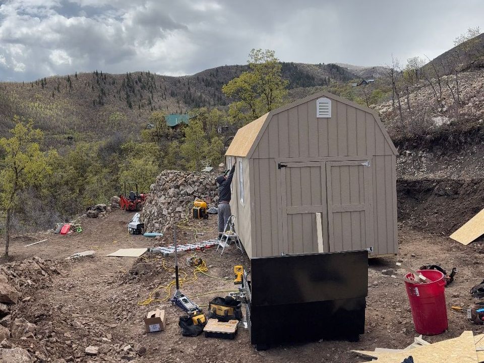 A small house with a garage attached to it is being built.
