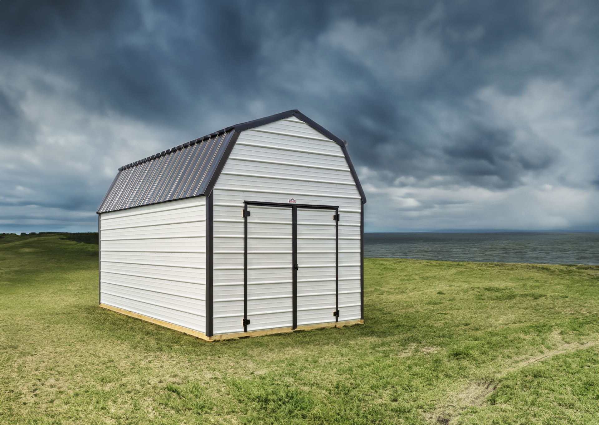 A shed is sitting in the middle of a lush green field.