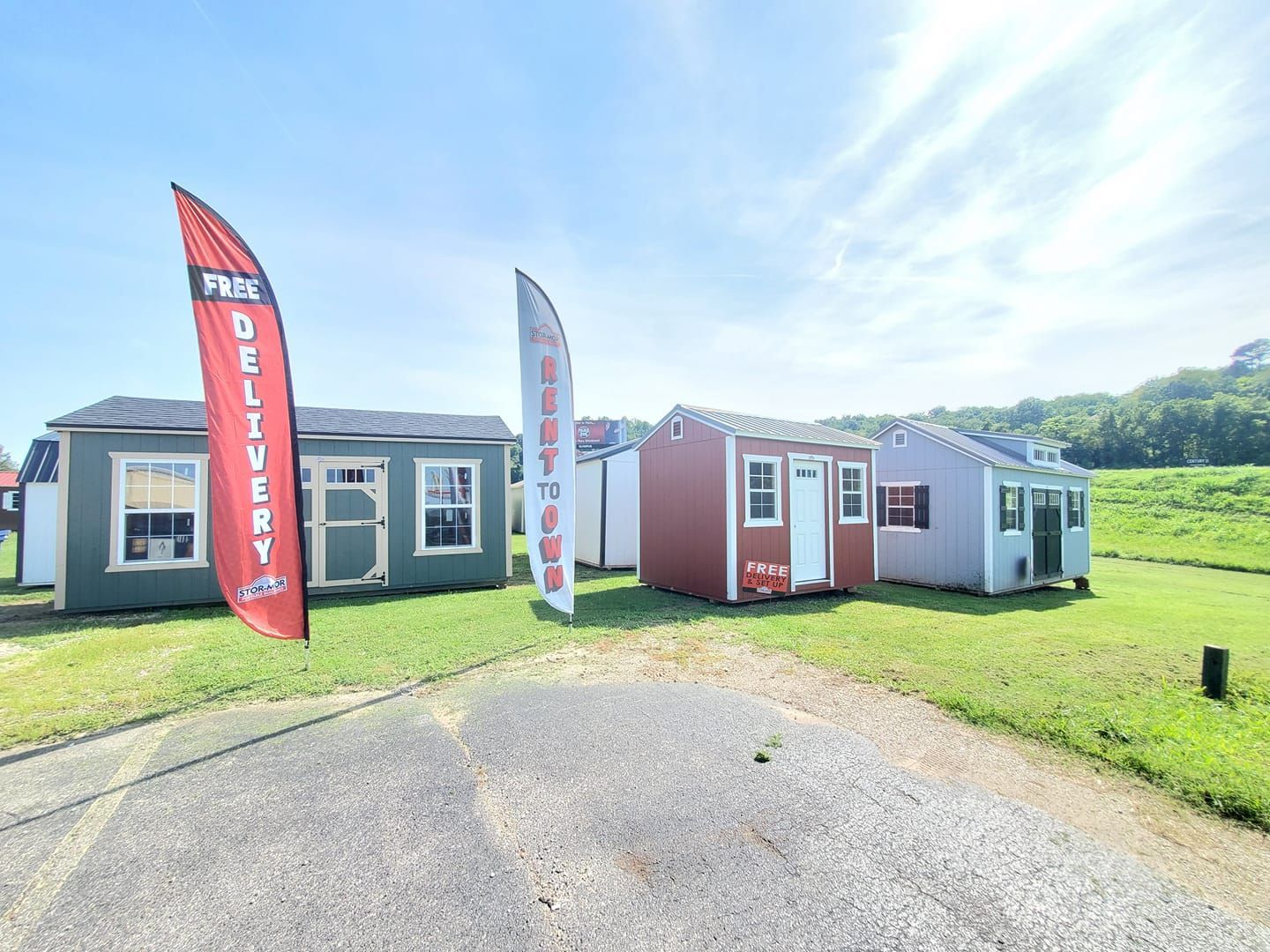 Stor-Mor dealer lot with large selection or building styles and marketing signage.