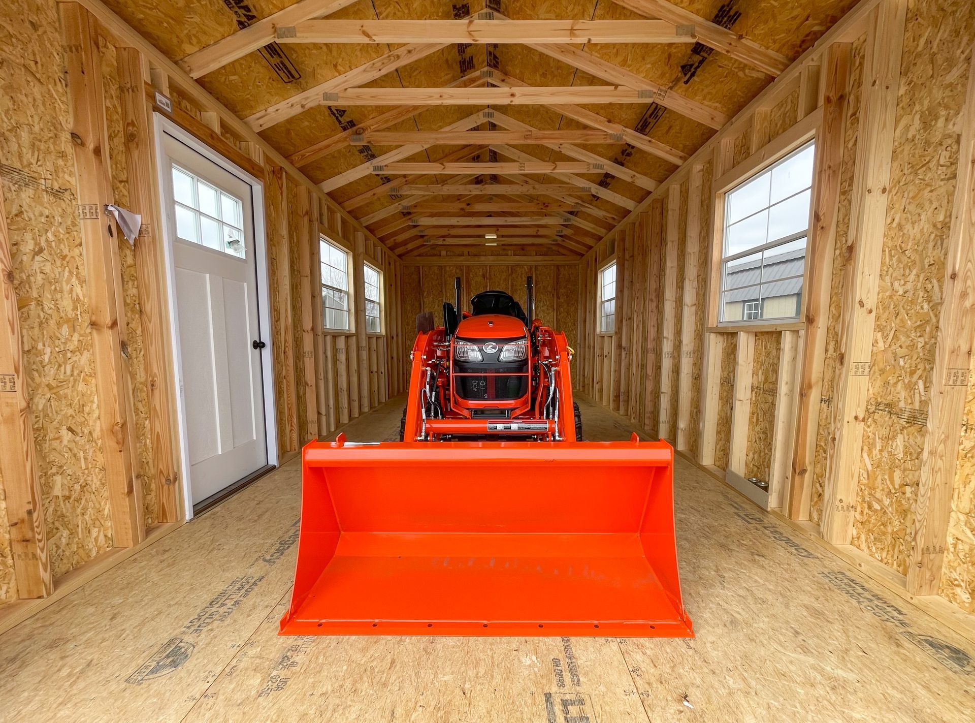 shed being used to store a lawn tractor