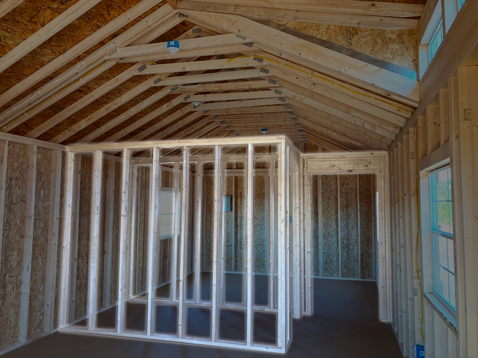 The inside of a building that is being built with wooden interior frames.