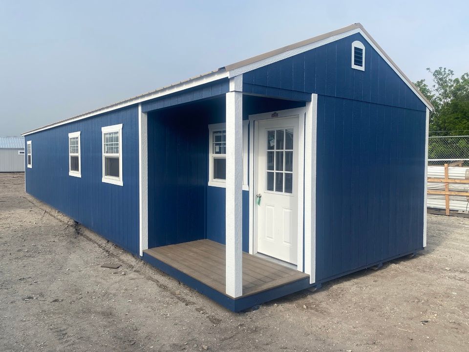 A blue shed with a porch and a door