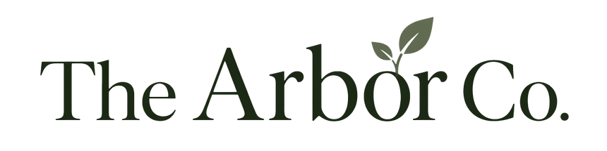 The Arbor Co. logo with dark green serif text and a small leaf accent above the “o”