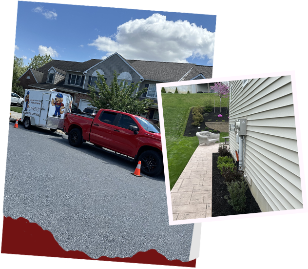 A red truck is parked on the side of the road next to a house.