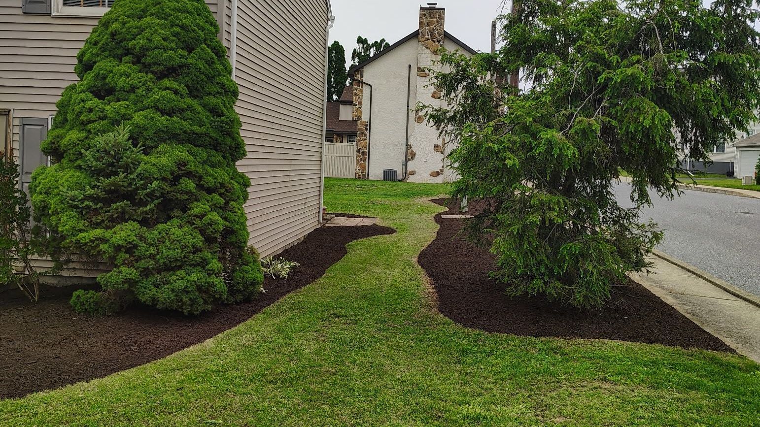 There is a house in the background and a lawn in the foreground.