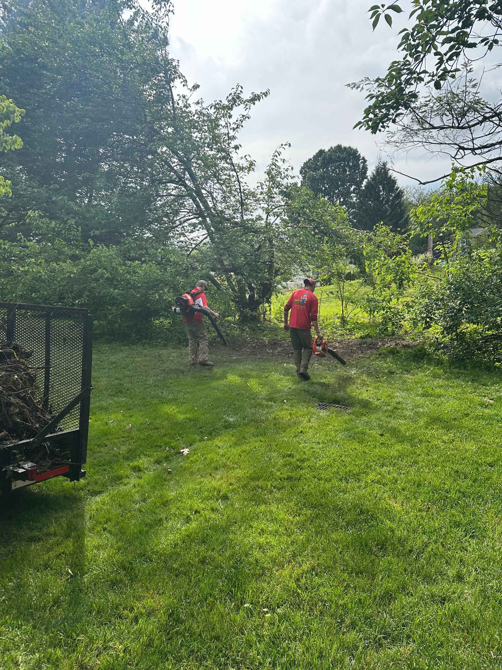 Two man with a leaf blower