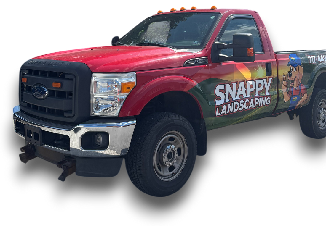 A red truck with snappy landscaping written on the side