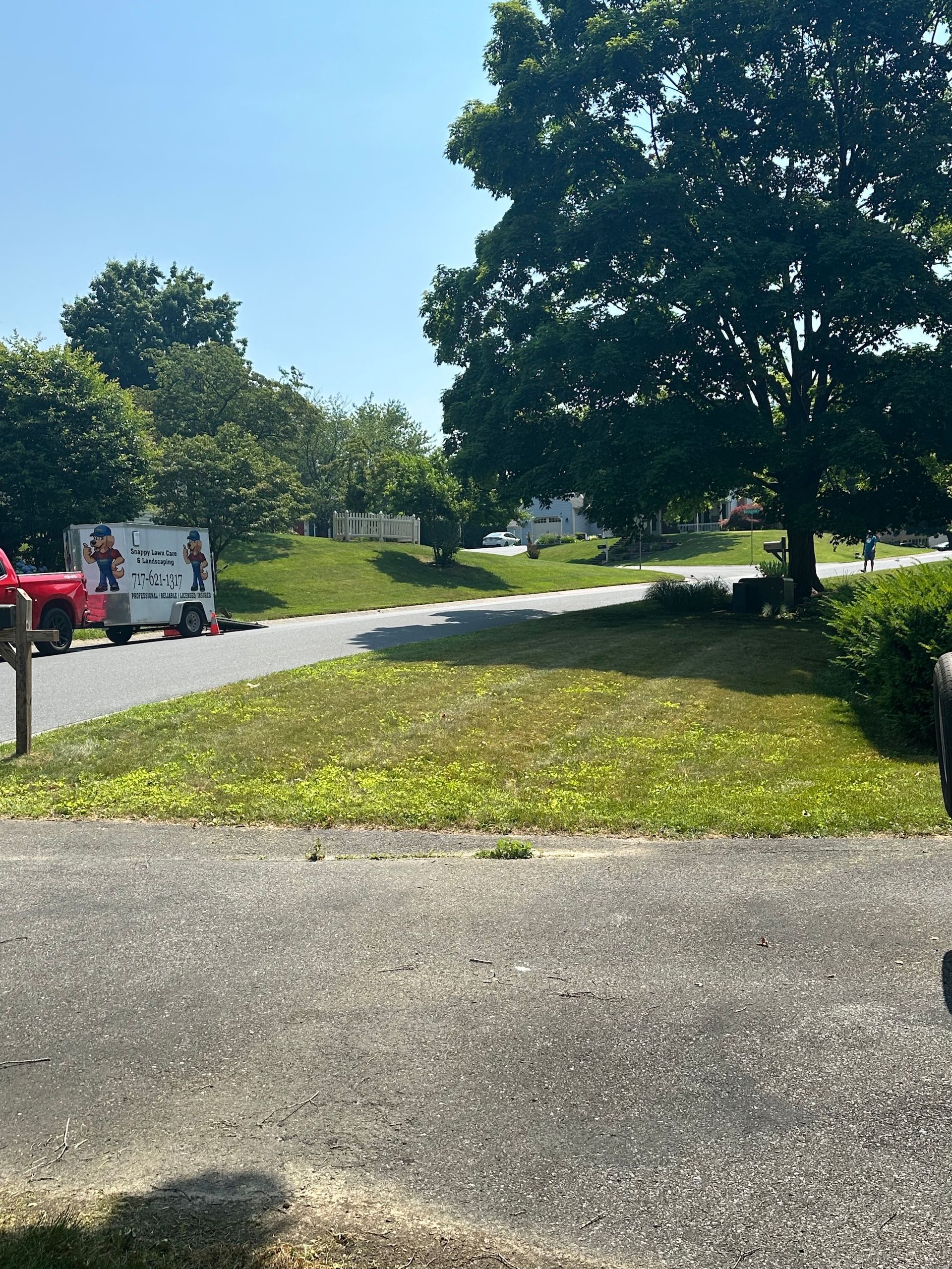 A red truck is parked on the side of the road