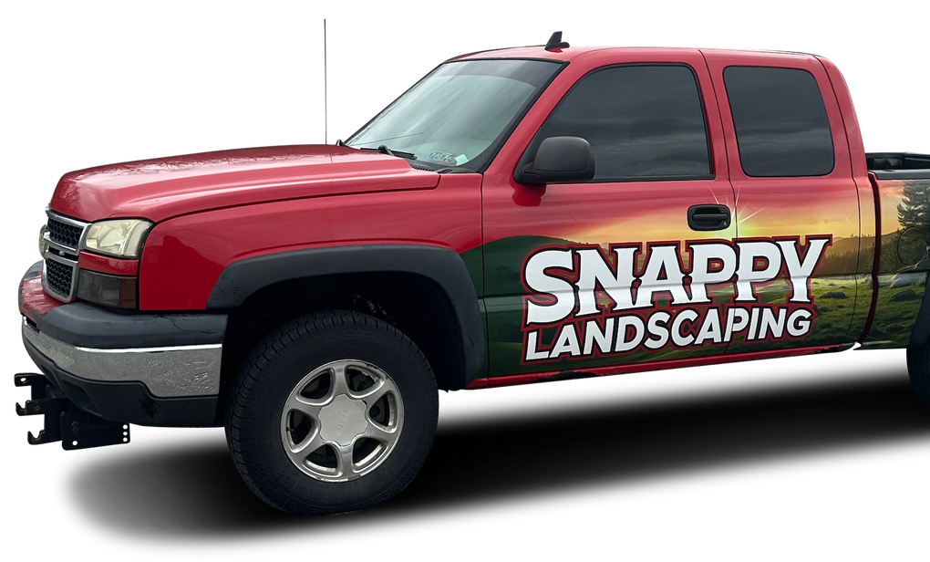A red truck with snappy landscaping written on the side