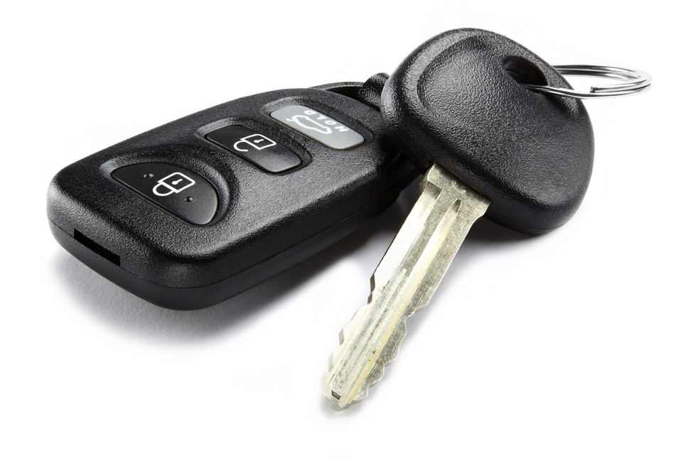 A close up of a car key and remote control on a white background