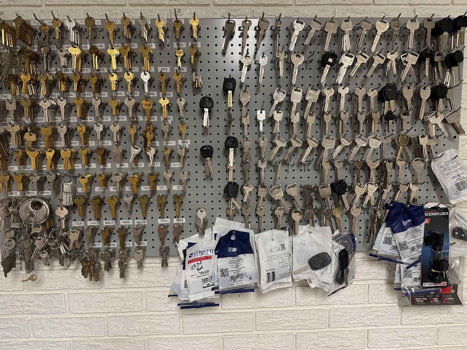 A bunch of keys are hanging on a wall.