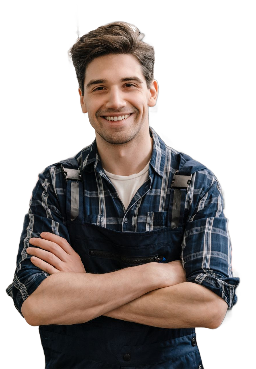 Man with arms crossed smiling, wearing blue plaid shirt and work apron.