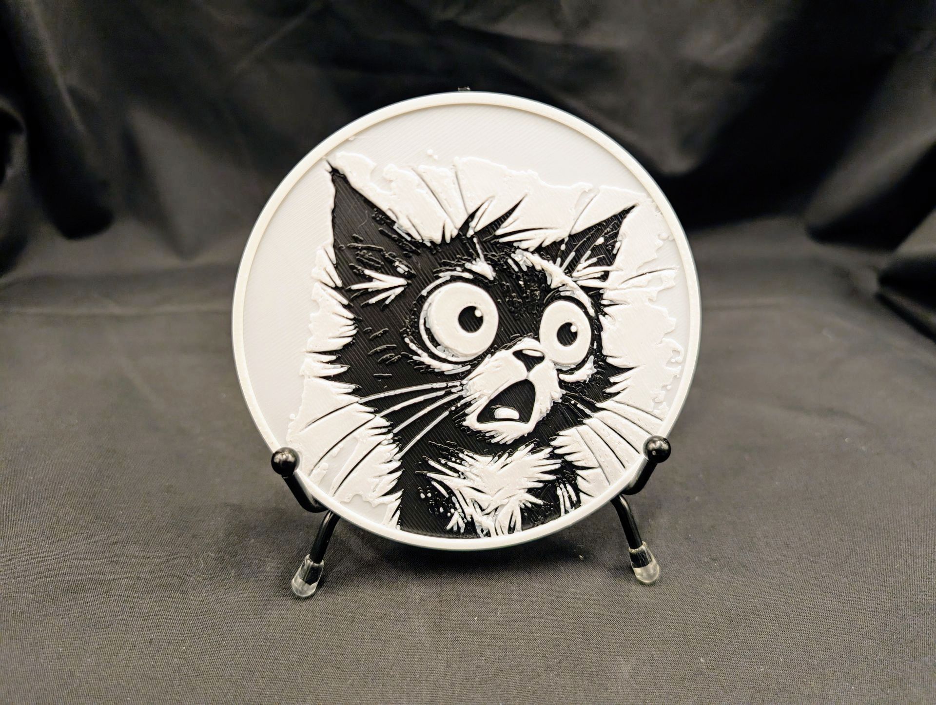 A coaster from a set of four. This one features a shocked cat named Sir Pounce-a-Lot.