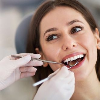 General Dentistry — Woman Having Teeth Examined in Fort Madison, IA