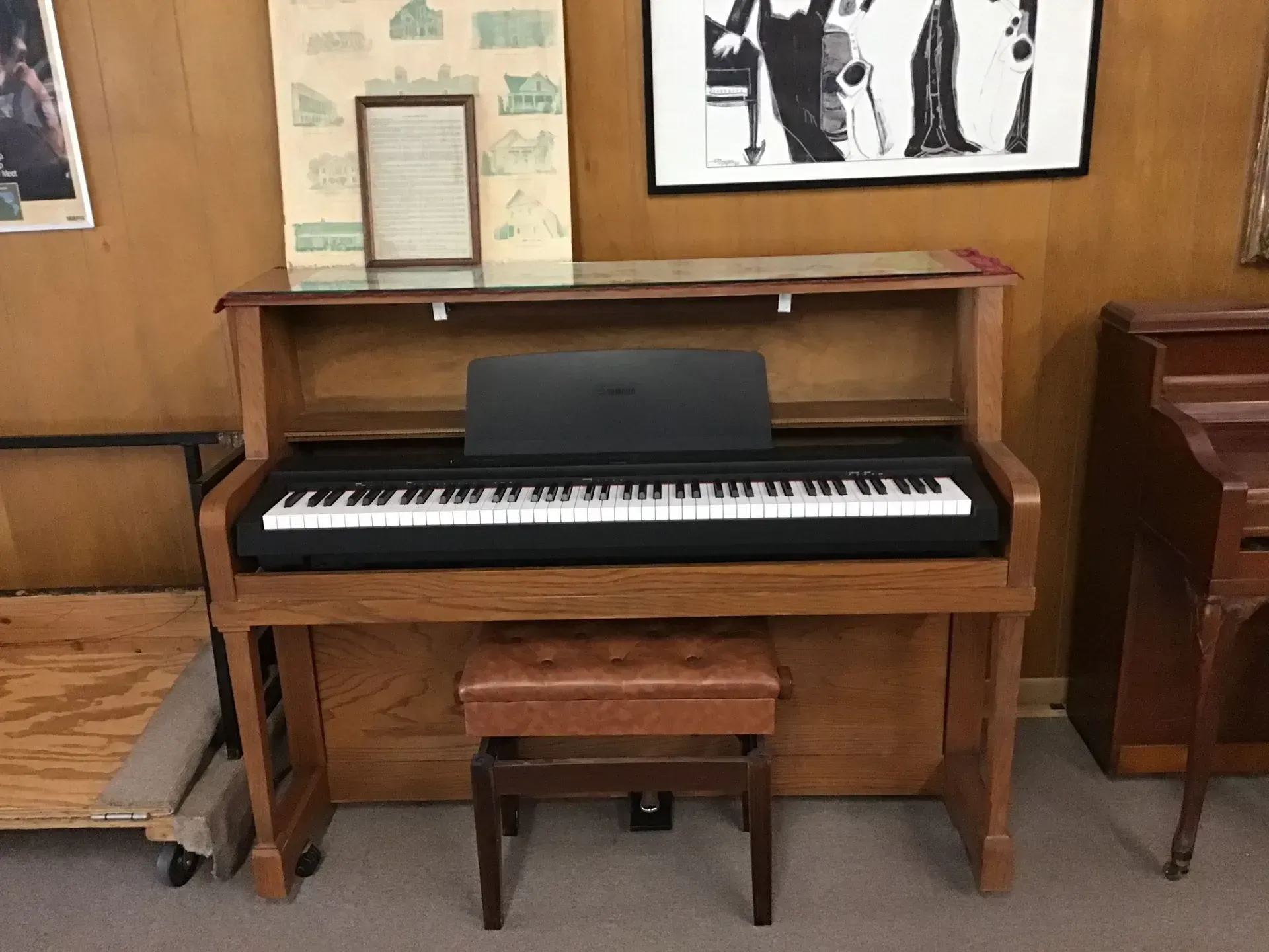 A piano with a stool underneath it in a room