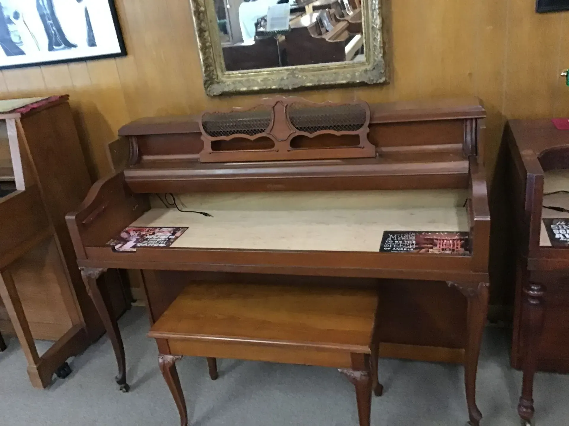 A wooden desk with a bench underneath it in a room.