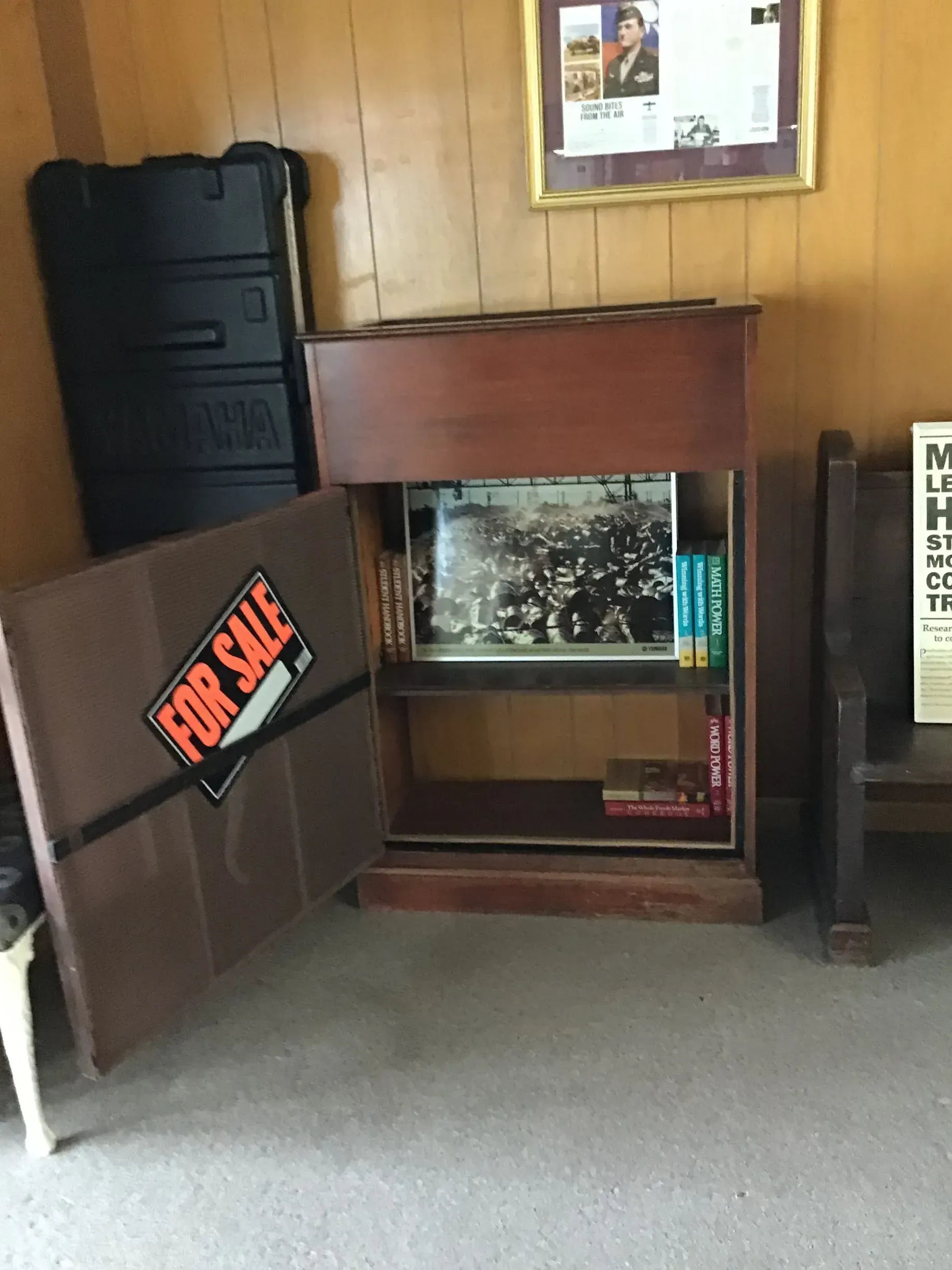 A wooden shelf with a for sale sign on it