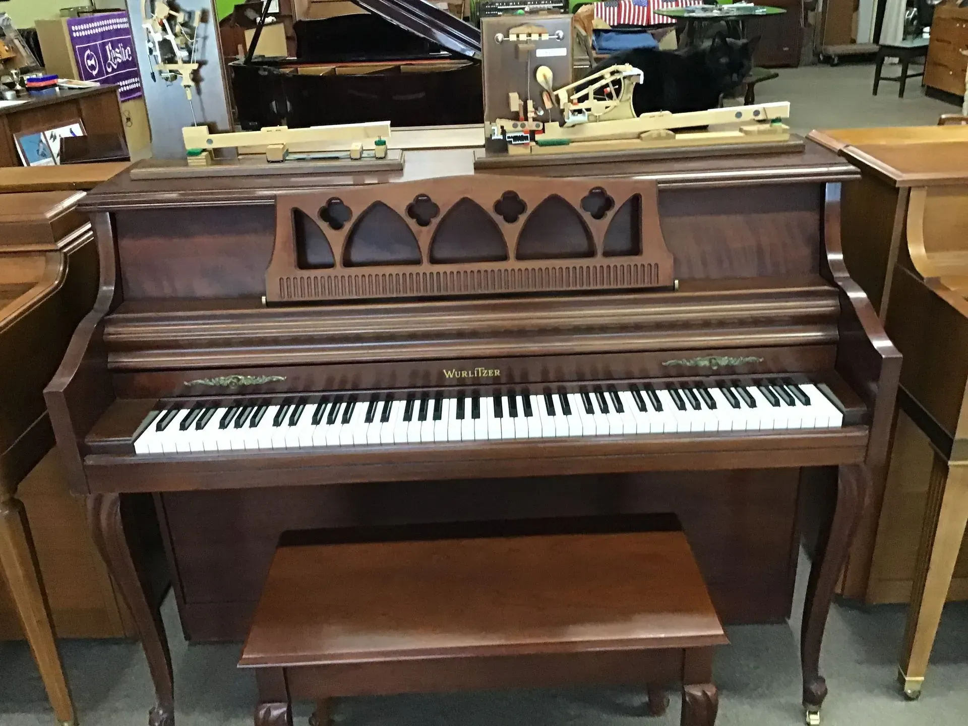 A piano with a bench in front of it in a store