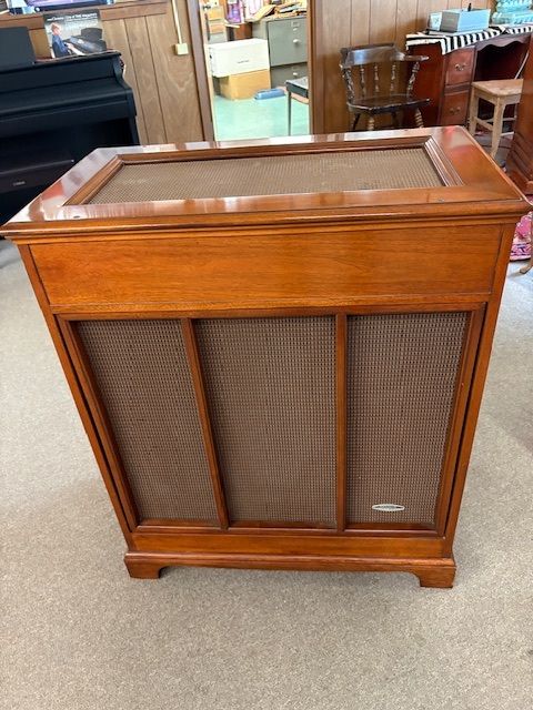 Wooden vintage radio console with speaker panels.