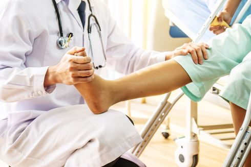 A doctor is talking to a patient while holding a clipboard.