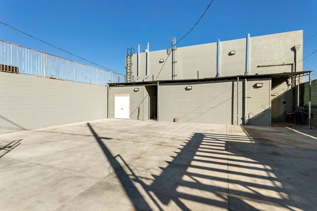 A large building with a lot of shadows on the ground.