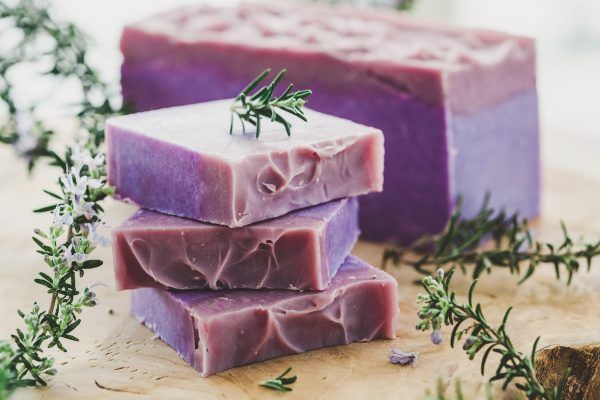 purple soap is stacked on top of each other on a wooden table .