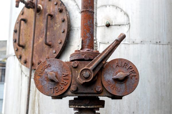 a rusty valve with the word airpel on it