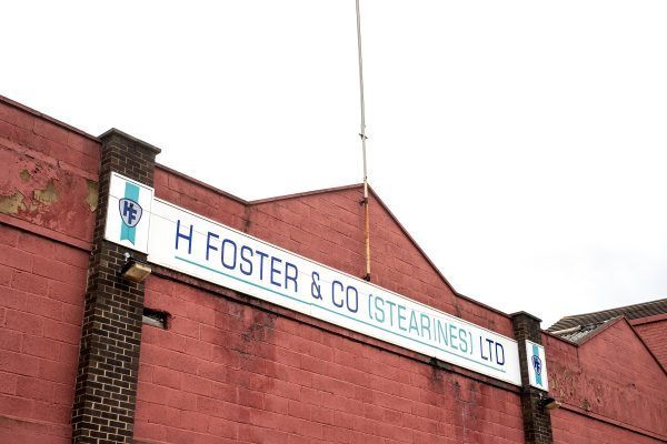 a red brick building with a sign that says h foster & co