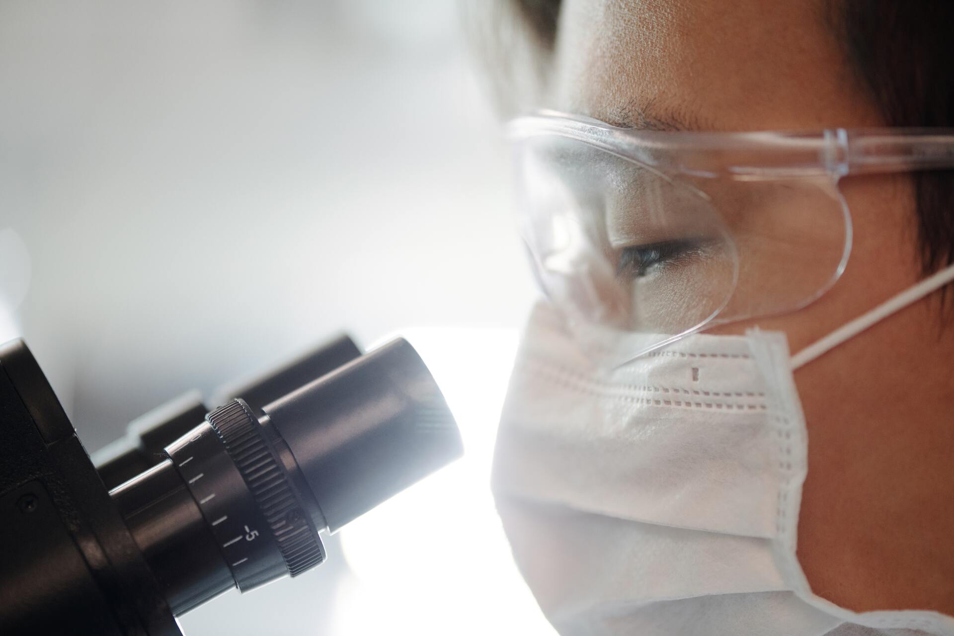 Person looking through a microscope DCRT