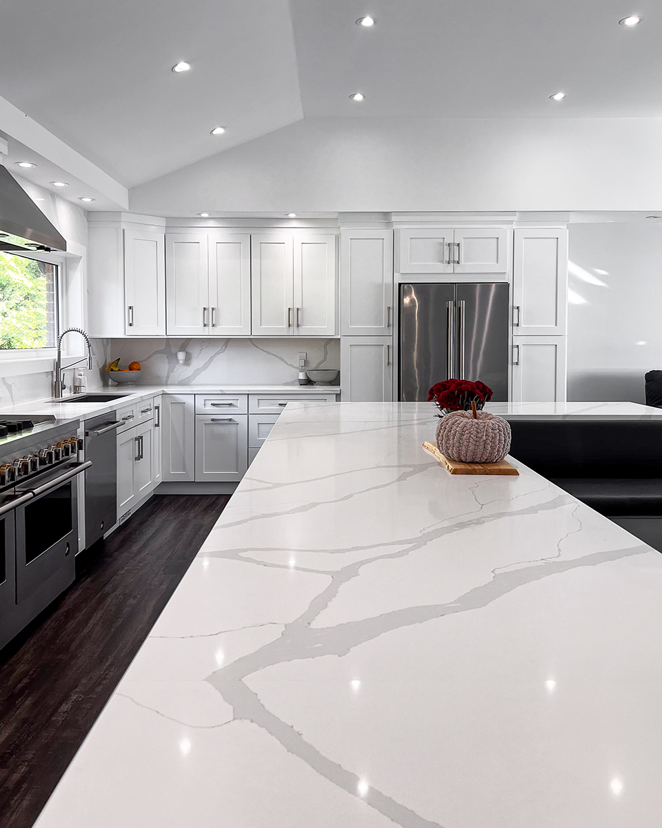 A kitchen with stainless steel appliances and white cabinets.