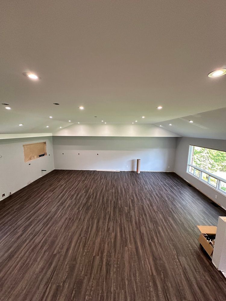 A large room with a wooden floor and a white ceiling.