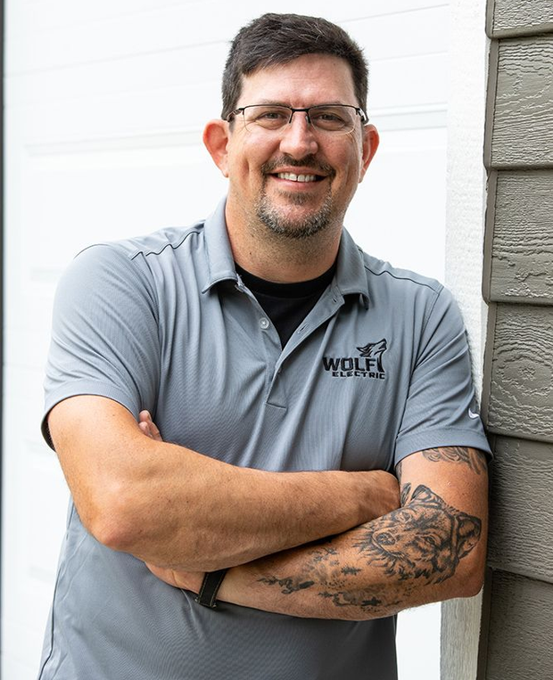 A man wearing glasses and a wolf electric hat
