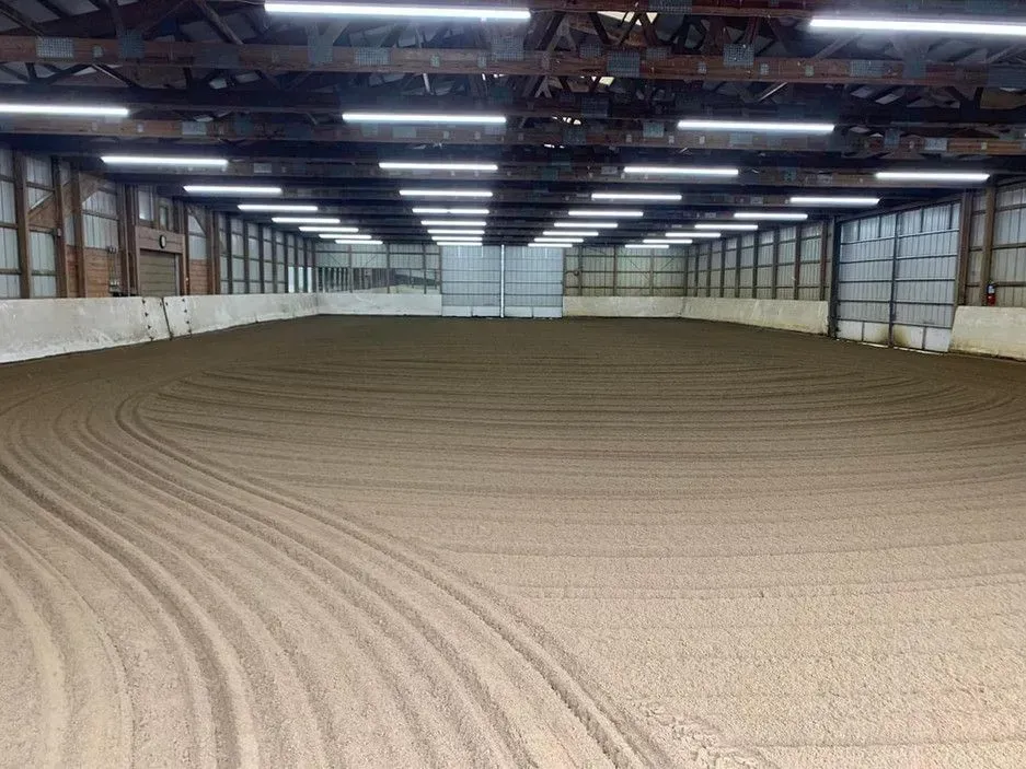 A large indoor arena with a lot of lights on the ceiling.